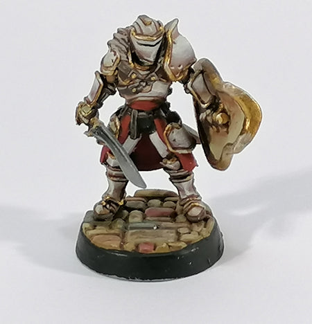 A kingsguard Shield Guard miniature painted with Ivory coloured armour with gold trim and red cloth.  The model is based on a Flagstone base which can be downloaded for free from the Lion's Tower