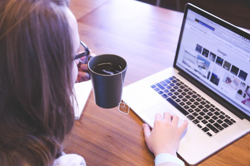 Girl working in office drinking tea