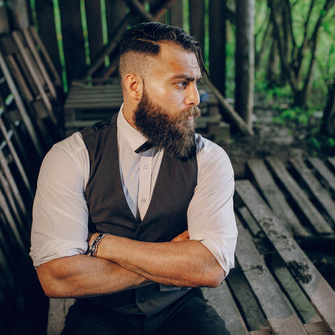 Cool looking guy with arms folded and a long groomed beard