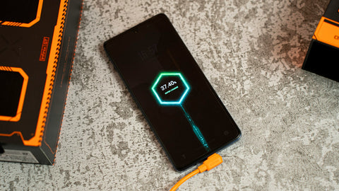 A black cell phone with a neon light on it