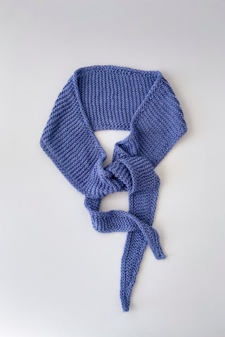 Petite Knits Sophie scarf knitted up in blue studio linen yarn by Erika knight on white background