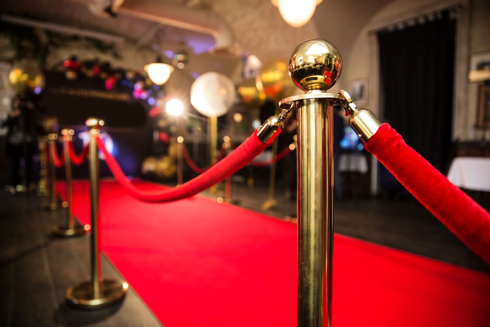 Red carpet between rope barrier in decorated great room