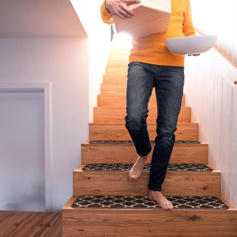 man walking down stairs with attachable carpet stair treads