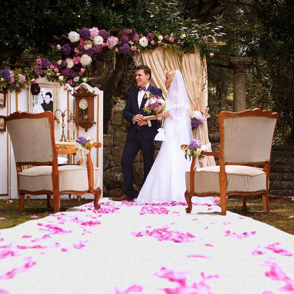 Bride and groom standing on white carpet aisle runner