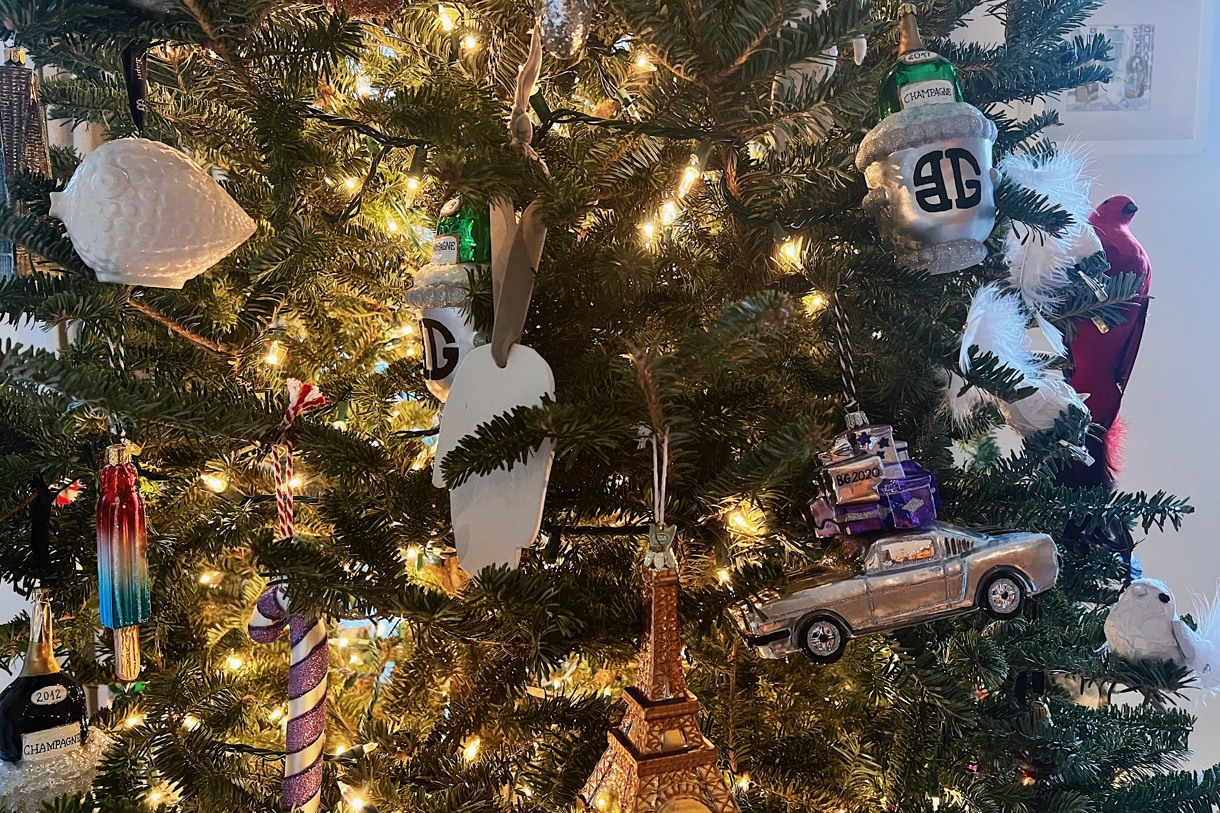 Clay hand ornament hanging on a Christmas tree with other ornaments