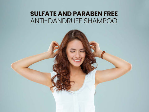 Joyful woman enjoying her healthy, curly hair with sulfate and paraben-free anti-dandruff shampoo