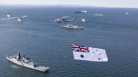 Large White Australian Ensign flown under helicopter