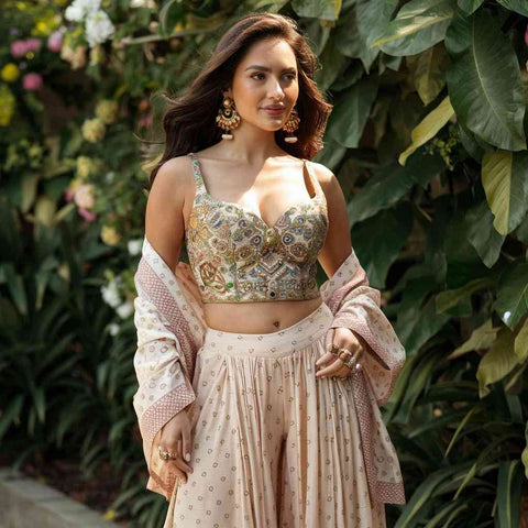 A modern look with a high-waisted skirt and heels complemented by a stunning Paithani blouse.