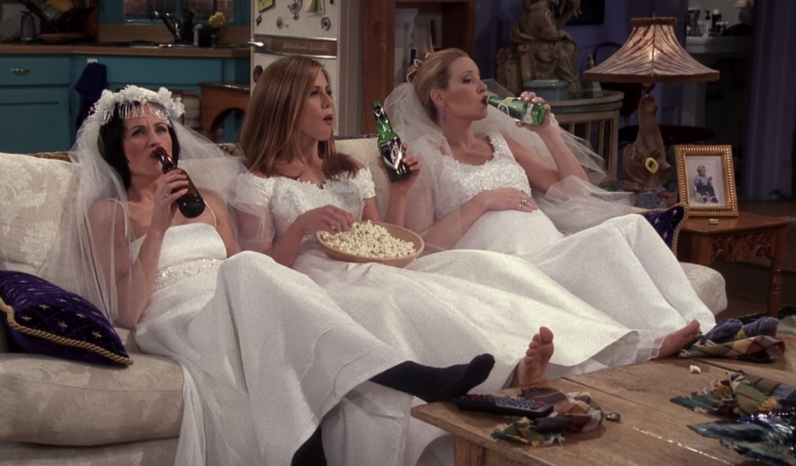 Monica, Rachel and Phoebe wearing wedding dresses in Monica’s apartment