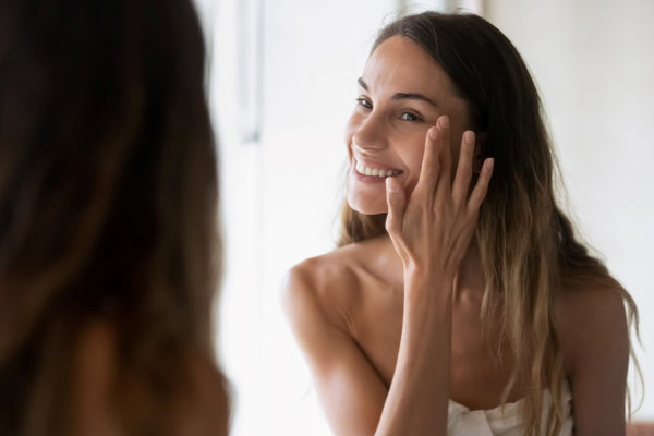 Woman applying collagen cosmetics