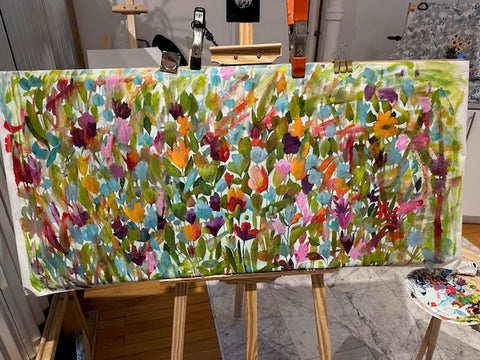 Large rectangle painting of bright colored florals in progress.