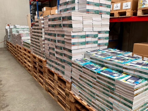 AME Workbooks piled up in warehouse