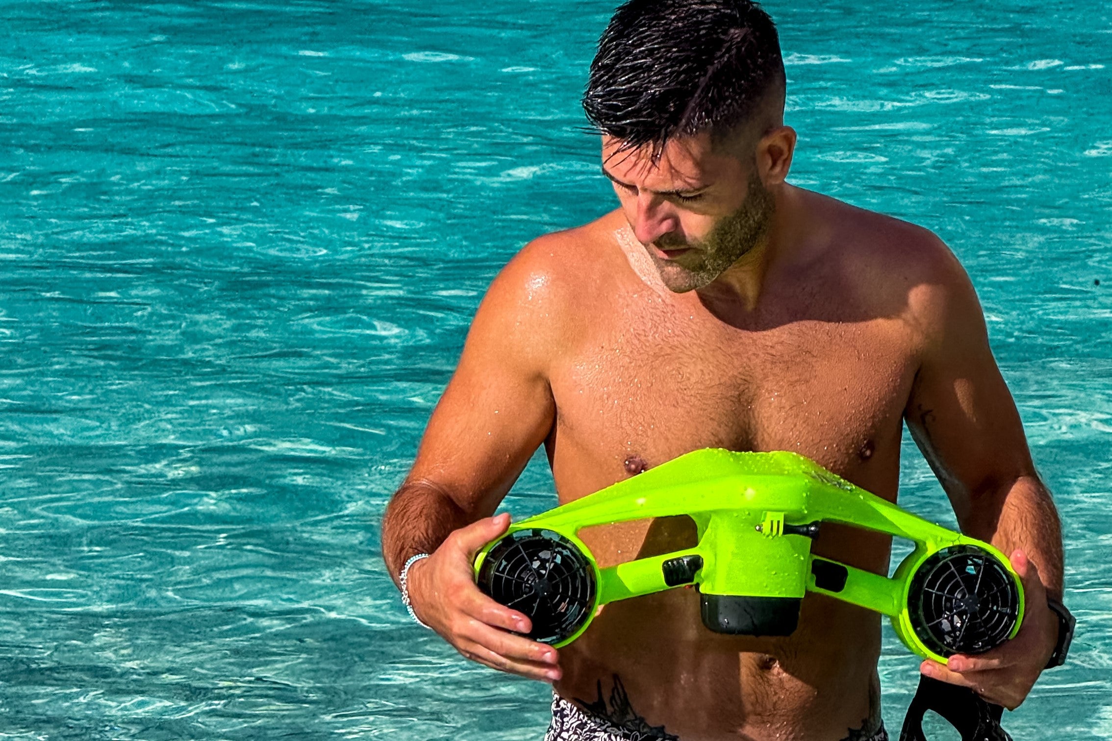 A man inspects his Underwater Scooter equipment before freediving