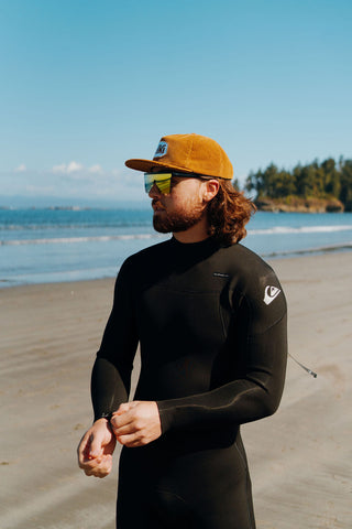 surfer wearing an alki hat