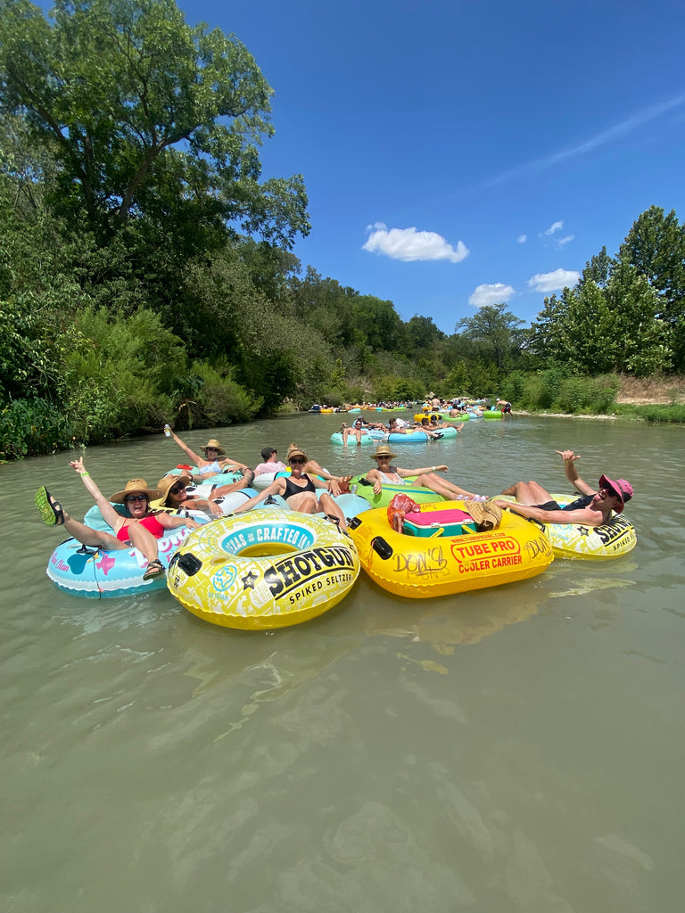 friends floating on the San Marcos River