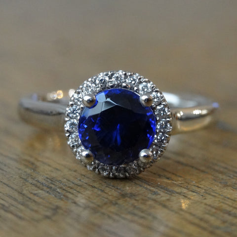 Diamond halo engagement ring with blue sapphire centre stone