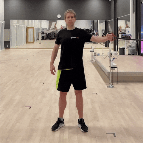 A man doing chest fly with resistance band
