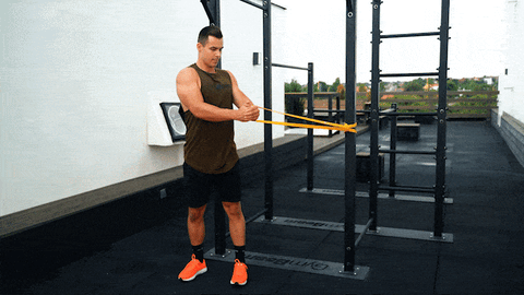 Image of man doing ab rotation using resistance bands