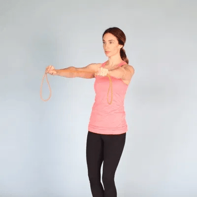 A woman doing band pull-apart using resistance bands