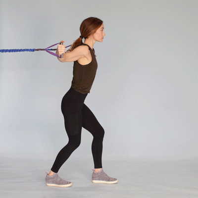 A woman performing chest fly using resistance bands