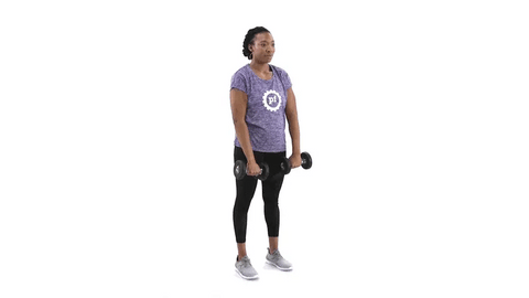 A woman practising front shoulder raise with dumbbells