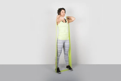 A woman doing front squat using resistance bands