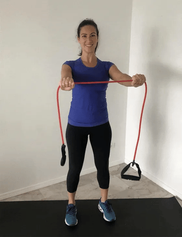 A woman performing horizontal arm extension using resistance bands