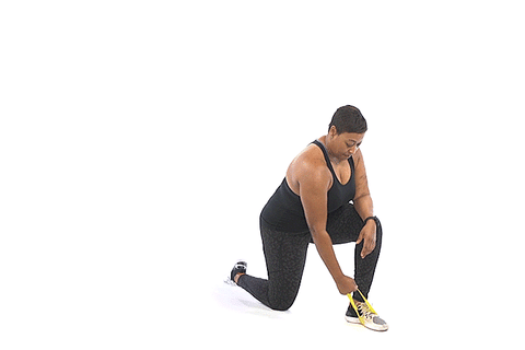 A woman performing kneeling row with resistance bands
