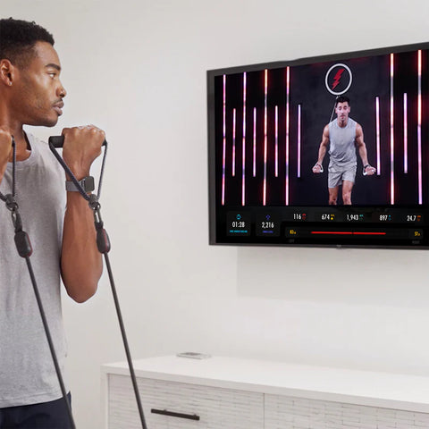 Man doing exercise at home with LIT Axis resistance bands