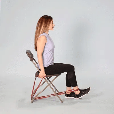 A woman doing leg extension using resistance bands