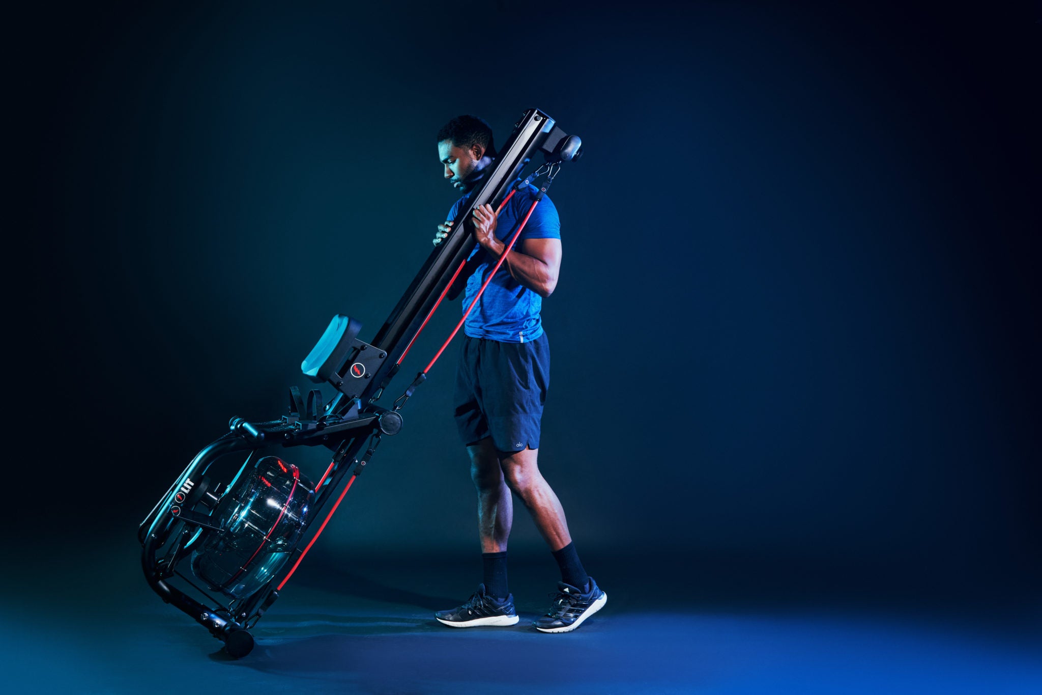 LIT Trainer Jarret Janako holding the LIT Strength Machine