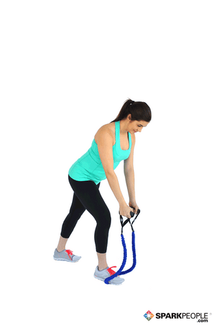 A woman doing reverse fly using resistance bands