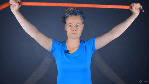 A woman doing shoulder and chest stretch with resistance band