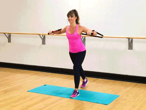 A woman doing standing chest press using resistance bands