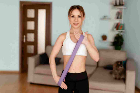 A woman doing exercise using therapy bands