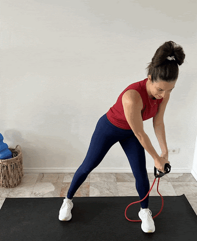 Woman doing wood chopper exercise with resistance band