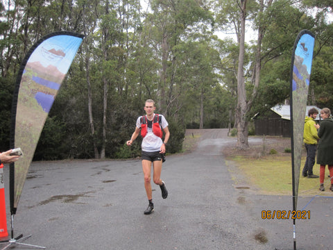 Damon Whish-Wilson crosses the finish line of the 2021 Cradle Mountain Run, finishing in 3rd place