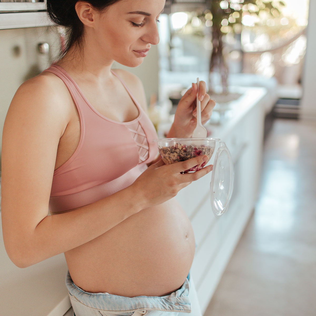 Young pregnant woman in the kitchen