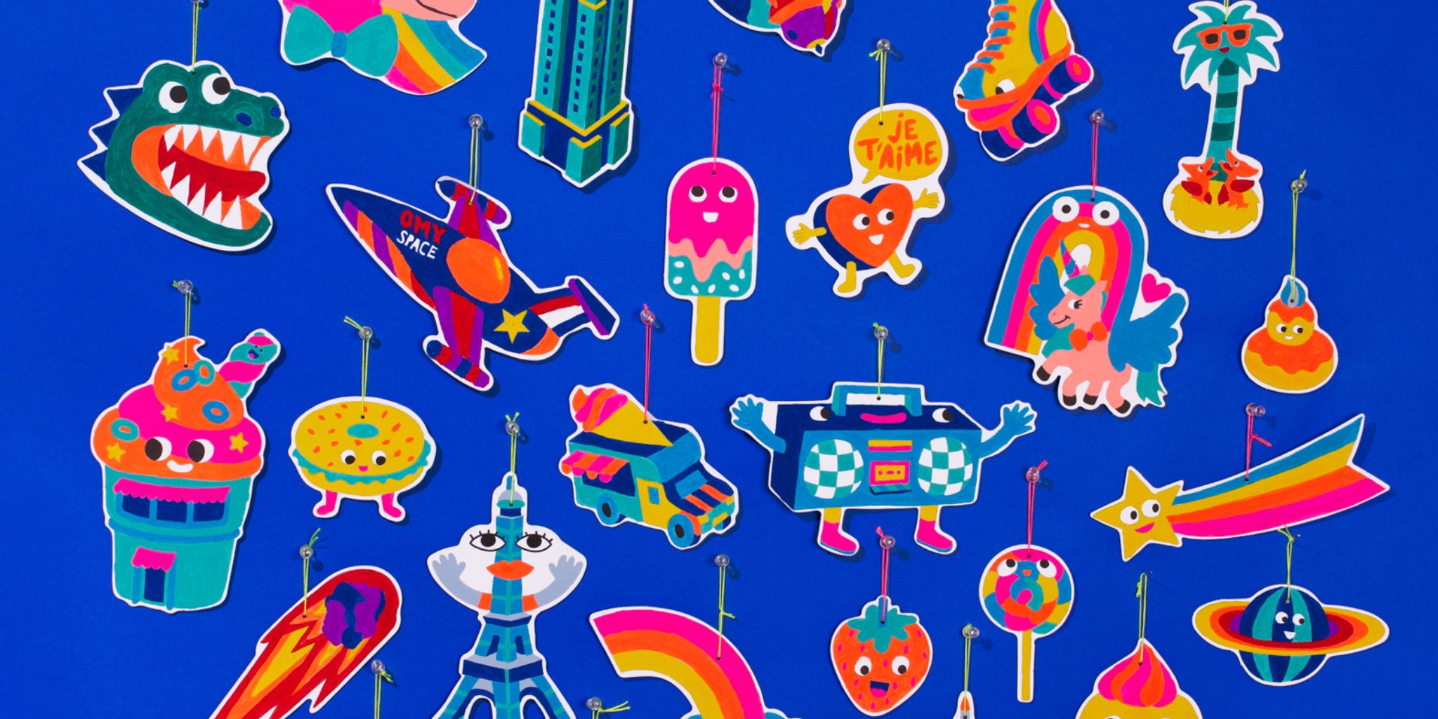 Décorations colorées peintes avec le kit Paint Box OMY, prêtes à être accrochées après une activité créative pour enfants