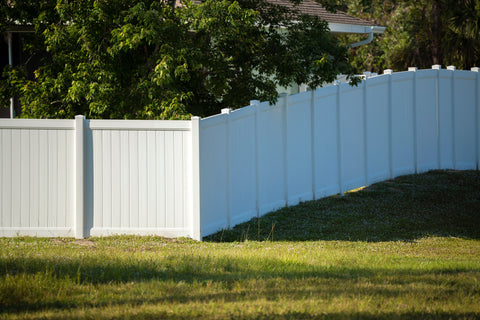 White vinyl fencing surrounding a property, offering a clean, modern, and low-maintenance boundary solution.