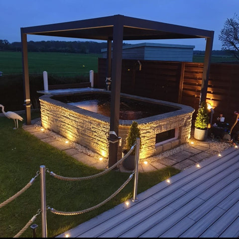 Pergola over a pond with lighting and a heron