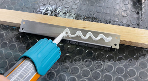 Assembly adhesive for attaching lashing strips in the mobile home