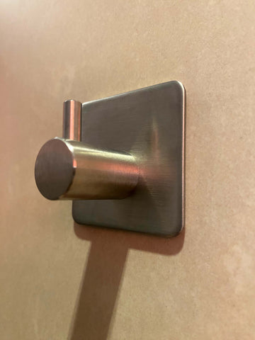 A self-adhesive hook on the door of a panel van.