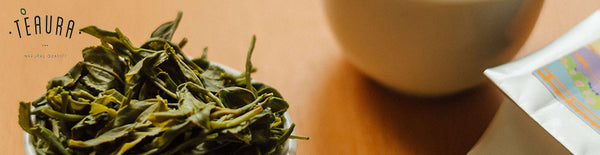 Dried Oolong tea leaves in a white teacup