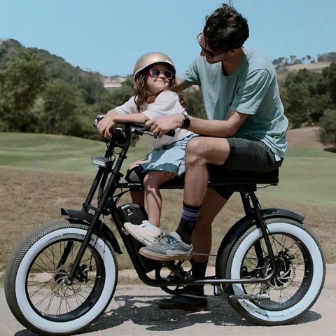 A parente in a 50 Rebels e-bike with a kid seated in the front of the new R-Series frame with front frame foopegs and extended seat