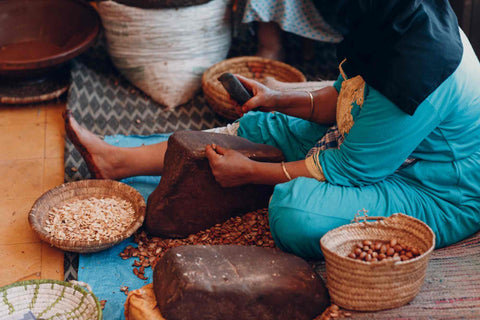 woman making argan oil by hand