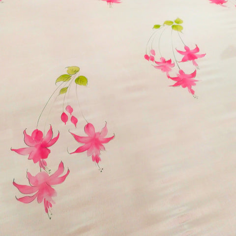 hand painted peach chiffon saree with fuchsia flower.