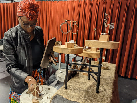 Jewelry designer Malika Green setting up a display table