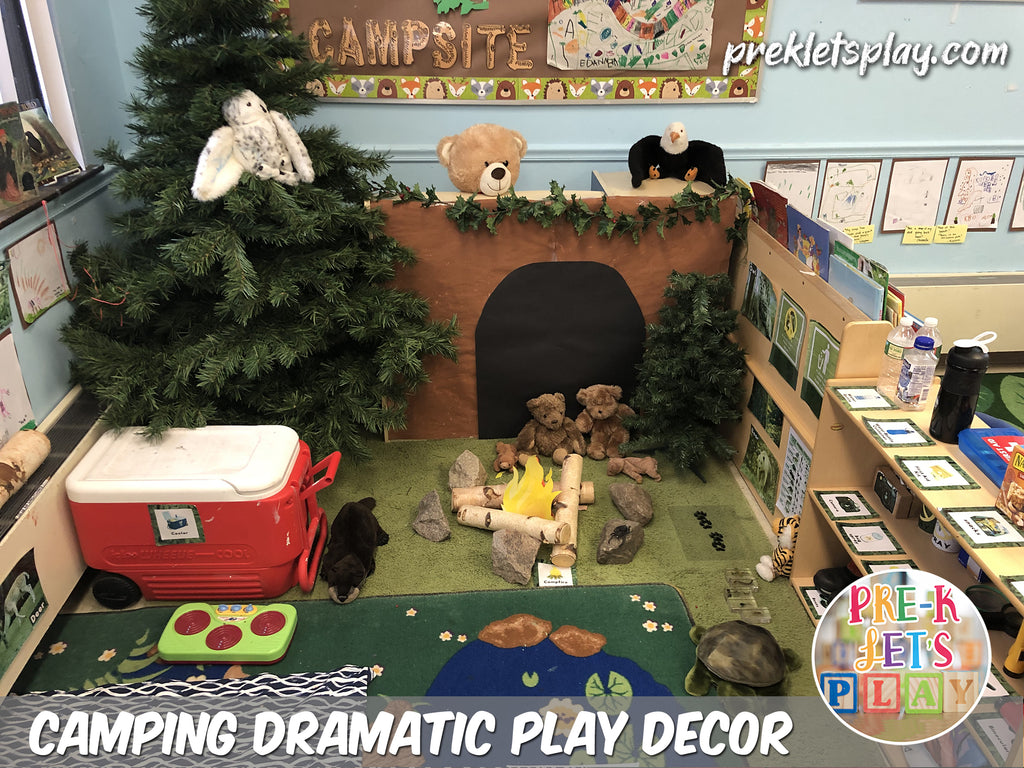 Students love to play and learn inside this camping dramatic play theme. This pretend play area supports imaginative preschool play and features signs, props, and classroom decor to make this space look like a campsite and woodlands.