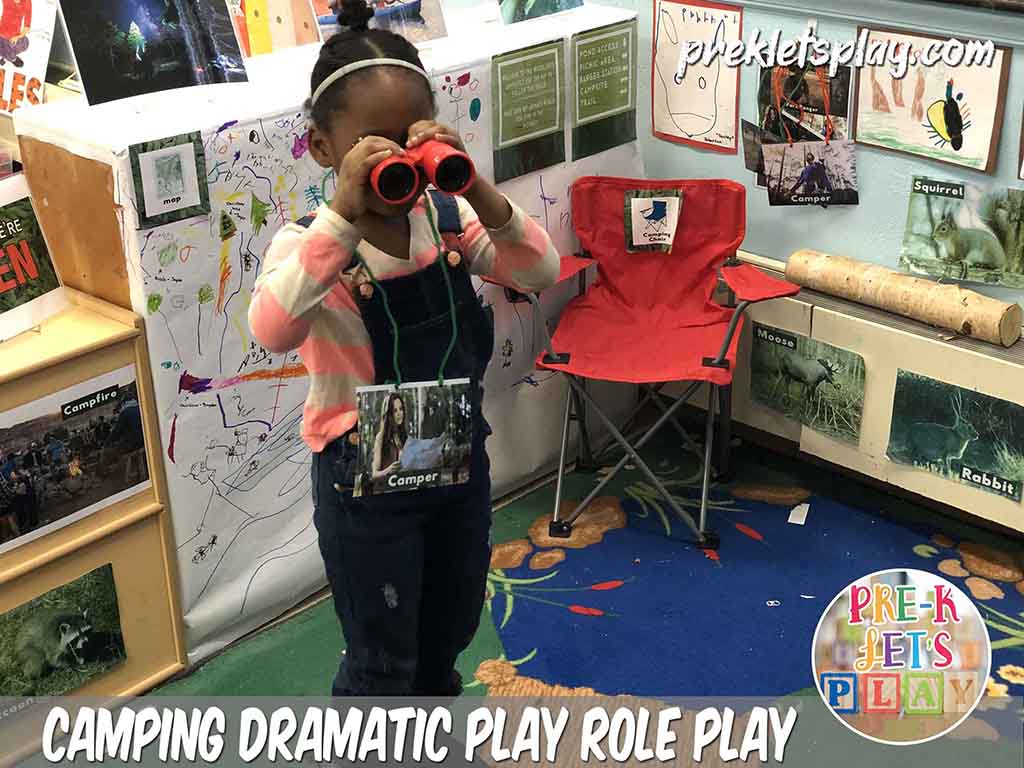Student role playing as a camper in in this dramatic play camping area . She enjoys using binoculars to go bird watching and looking at other woodland animals for pretend play area.